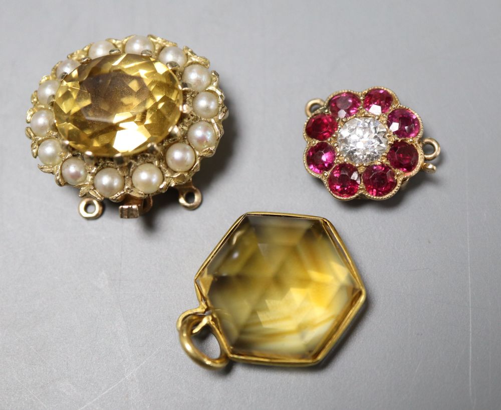 A yellow metal, ruby and diamond set flower head clasp, 12mm, a citrine and seed pearl set clasp and a citrine set pendant.
